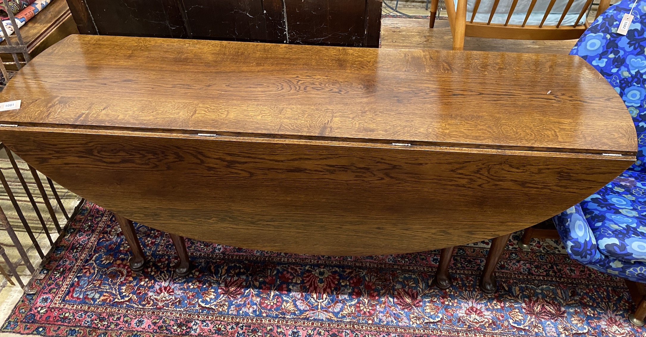 A reproduction 18th century style oak drop leaf wake table, length 196cm, width 153cm extended, height 77cm